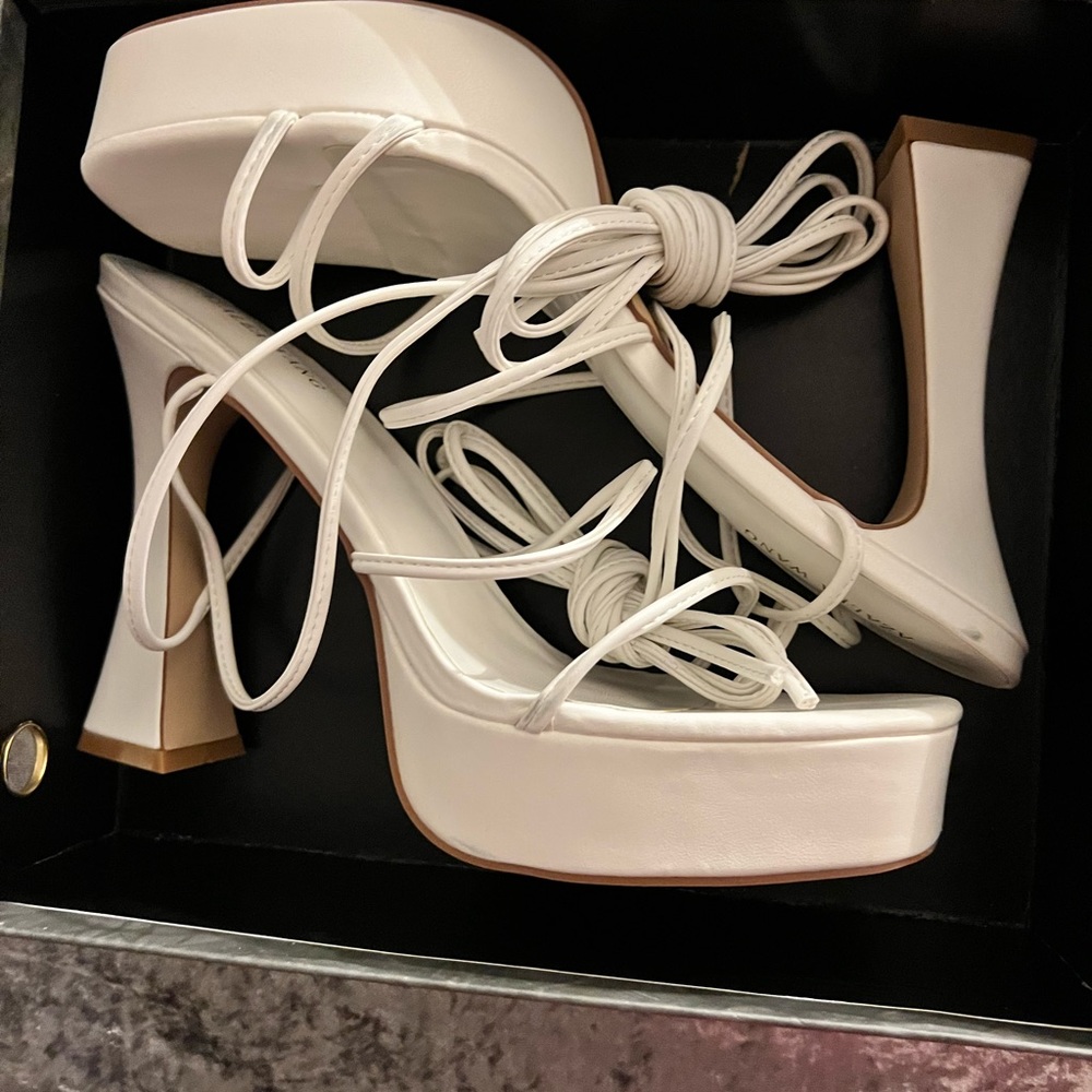Off white platform heels wrap around the leg